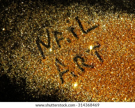 Inscription Nail Art on golden glitter sparkle on black background