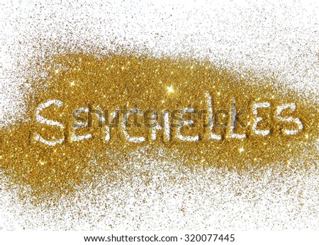 Inscription Seychelles on golden glitter sparkle on white background