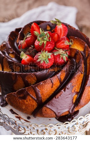 Cake with strawberries and chocolate glaze on the base.selective focus