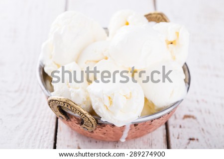 Cream white, ice cream balls in a metal authentic bowl.selective focus