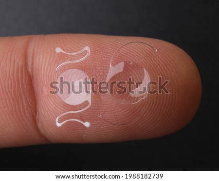 photo of two types of intra ocular lens on finger tip Stok fotoğraf © 