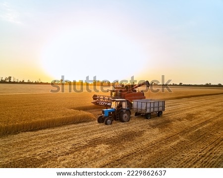 Similar – Image, Stock Photo Aerial view of farmer cleaning dirt of combine in agricultural field