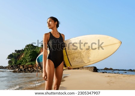 Similar – Image, Stock Photo Surfer standing at the beach with surfboard