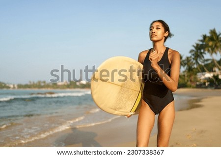 Similar – Image, Stock Photo Serene woman on surfboard in sea