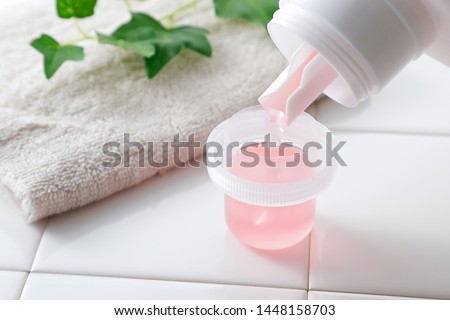 Liquid detergent in measure cup Foto stock © 