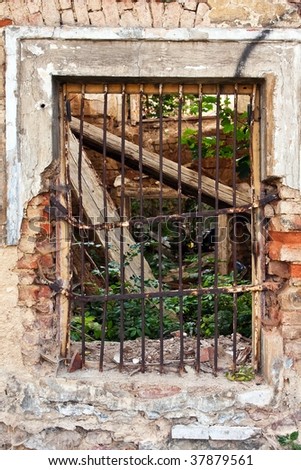 barred window in the ruined house