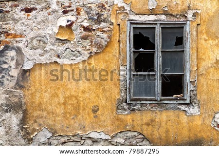 broken window on the yellow  wall