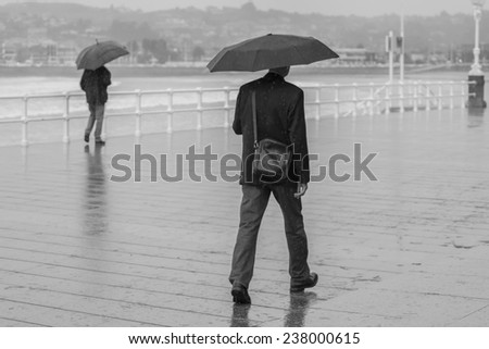People with umbrella walking around town