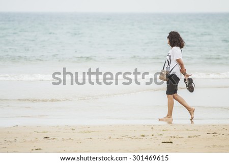 Women walking along the seashore