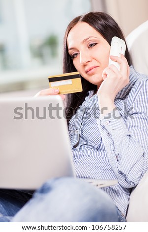 Woman with notebook buying something with creditcard onlineshopping concept