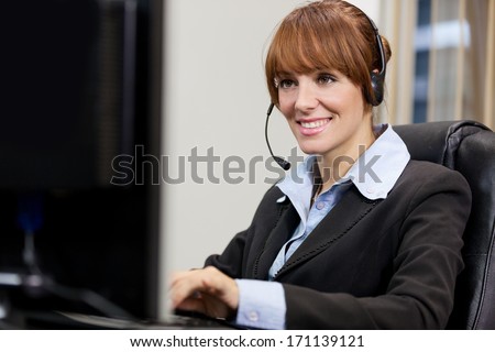 Brunette female support assistant working at the help desk
