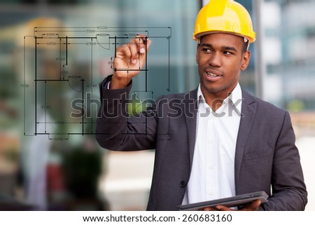 Photo of African construction engineer drawing with a digital pen