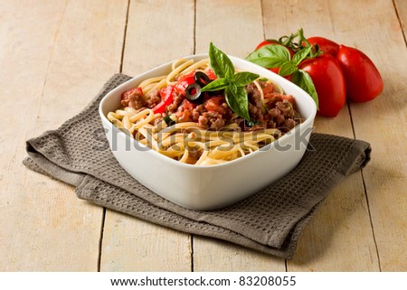 photo of delicious italian pasta with meat sauce on wooden table