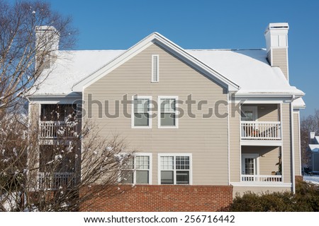 American dream house in the suburban village with snow covered the roof in winter season, located in USA