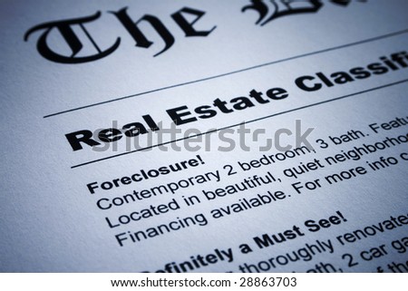Closeup of real estate classified ads on newspaper