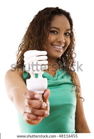 Stock image of girl holding an energy saving compact flourescent light bulb over white background, selective focus on hand and light bulb.
