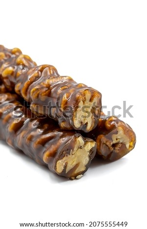 Sausage walnuts on a white background. Turkish walnut raisin sausage sweet. A sweet snack made by drying molasses and walnuts. local name ceviz sucuk Stok fotoğraf © 