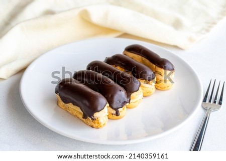 Chocolate eclairs cake on a white background. close up ストックフォト © 