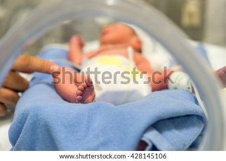 Similar – Image, Stock Photo Baby reaching for feet, dimpled baby hands, triangle print blanket and pants