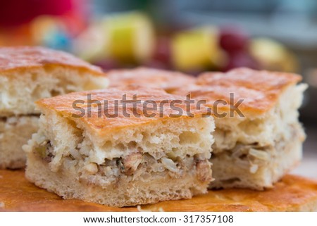 Meat pie. Pie dough. The filling is rice and meat. Side view. Close-up.
