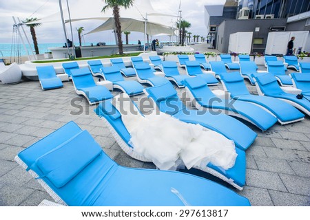 The bridal dress is laying on the sunbed in the recreation zone.