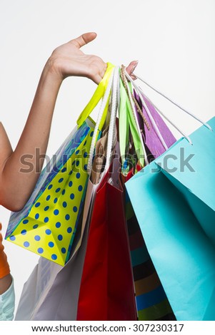 Seasonal discounts. Hands of the girl with packages on shopping during seasonal discounts.