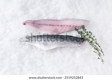 Similar – Foto Bild Zubereitung von Bass-Fischfilets in mediterraner Sauce mit Tomaten, Oliven und Kapern in einer Backform auf rustikalem Holzgrund mit Zutaten. Ansicht von oben