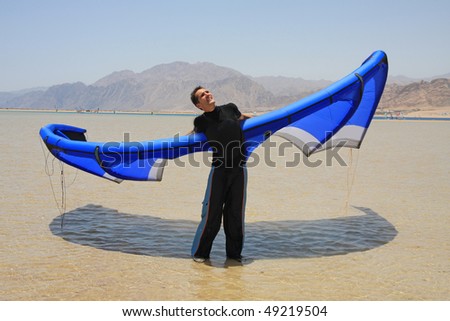 A man with the blue kite.
