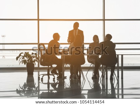 Group of managers sitting in the office and listening to discourse of their partner. Panoramic window on background Stock fotó © 