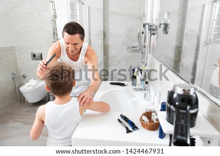 Similar – Image, Stock Photo Father making haircut for son at home