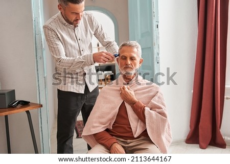 Similar – Image, Stock Photo Father making haircut for son at home