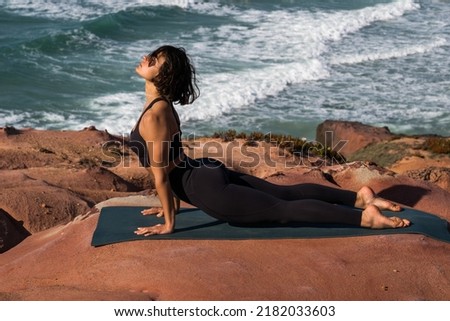 Similar – Image, Stock Photo Barefooted women practicing yoga in mountain pose