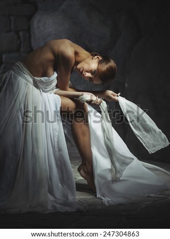 beautiful young lady sat down to relax in a long white dress