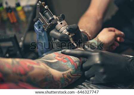 Similar – Image, Stock Photo Master doing tattoo on forearm of male customer