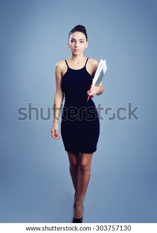 businesswoman holding papers in hands