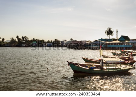 PhuQuoc, Vietnam - November 1st, 2013: These small boats were anchoring in harbor at sunset in HamNinh harbor, PhuQuoc, Vietnam