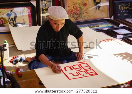 Painter artist/HoChiMinh, Vietnam   February 9th 2015: This artist was painting in his shop, in HoChiMinh, Vietnam