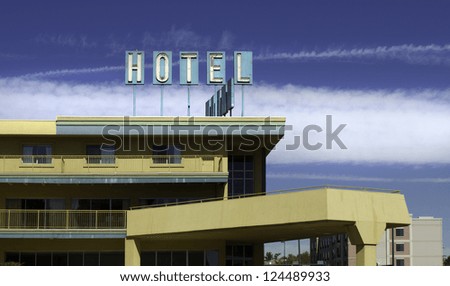 Old hotel, painted in pastel colors, on a clear day.