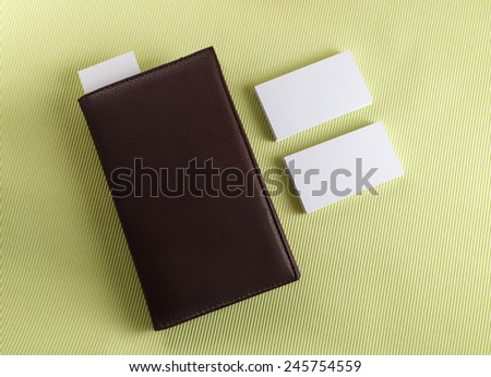 Notepad with business cards on a green background. Template for branding identity for designers. Top view.