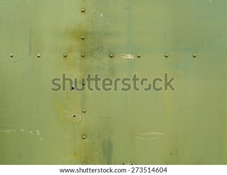 Abstract painted matte green metal background texture with rivets. Riveted  military green metal.