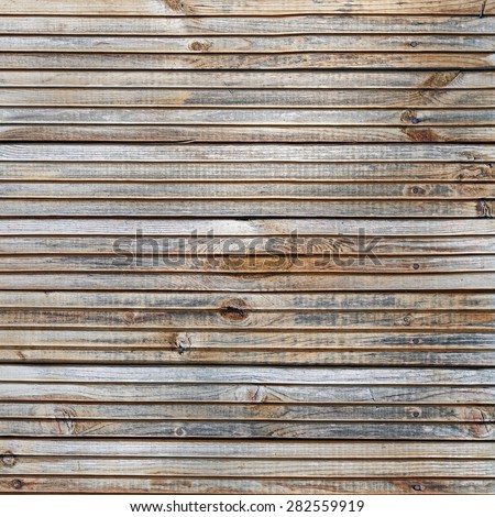 Wood plank texture. Weathered wooden background with knots and nails.