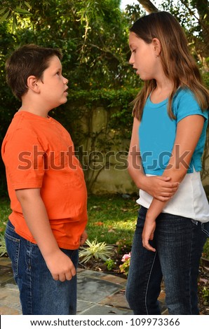 Two kids tallking/Siblings in Conversation/Two childern talking on path