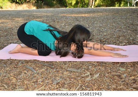 Young Asian woman doing her yoga/Outdoor Yoga/Young woman performs her postures in a park environment.