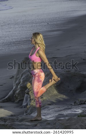 Mature woman doing yoga at the beach/Morning Yoga/Woman doing her yoga at the beach during the early morning