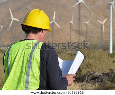 Engineer inspecting Site/Project Manager at the Wind Farm/Man working in the enviromental