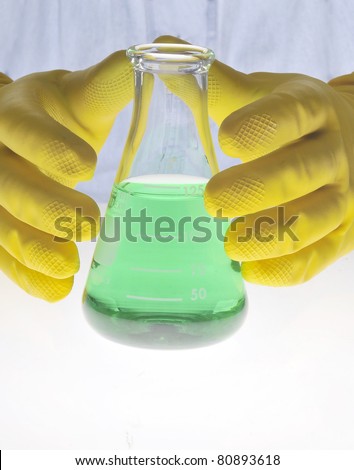 Gloves holding beaker/New Green Solution/Protective gloves holding chemistry