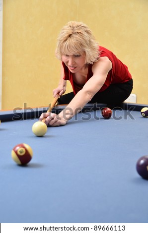 Woman at pool table/Woman at Pool Table/Woman playing a game of pool
