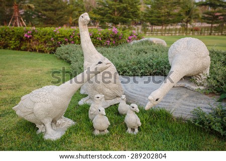 stone goose family sculpture in the garden