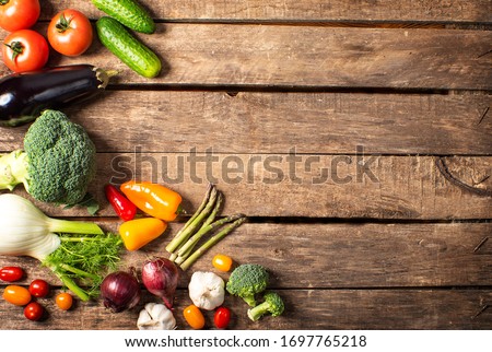 Exposition of fresh organic vegetables on wooden table. tomato, pepper, broccoli, onion, garlic, cucumber,  eggplant, black Eyed Peas