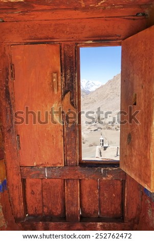 The window  open to the view of Himalaya range at Lamayuru monastery. Ladakh, India.